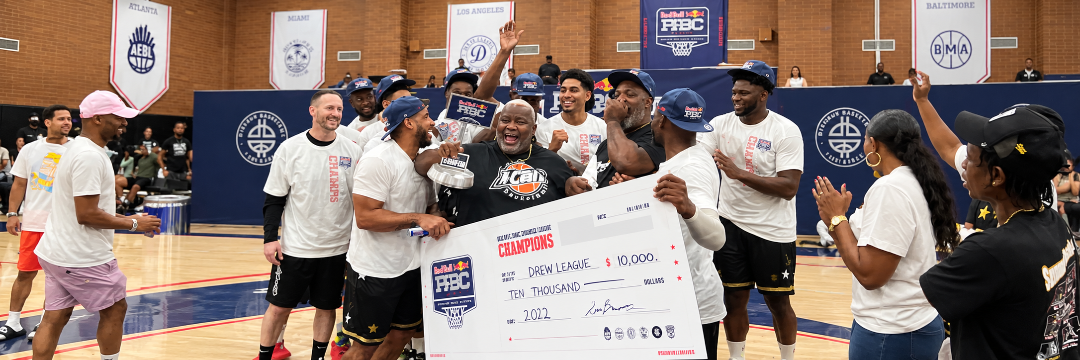 Drew League championship celebration — team holding $10,000 Red Bull Pro-Am Champions check